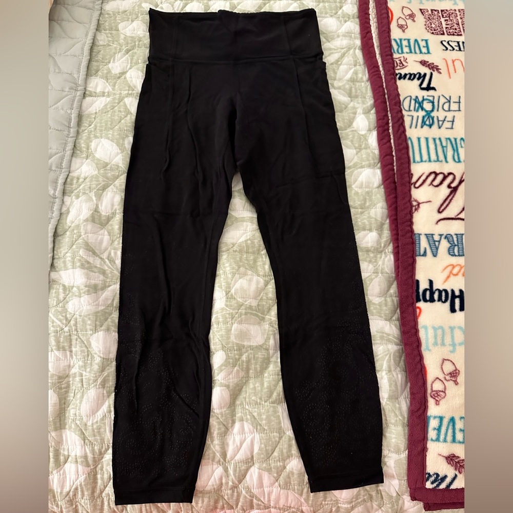 Black athleta leggings with pockets and swirly detailing